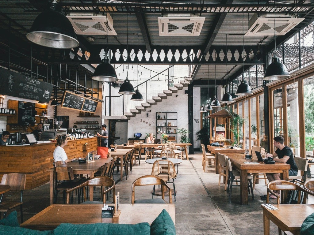 Brown and gray concrete store with tables and chairs